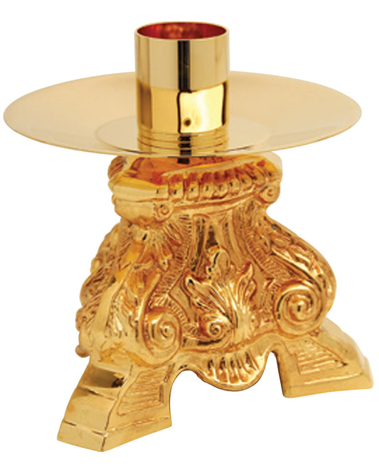 Gold candle holder with intricate designs on a white background