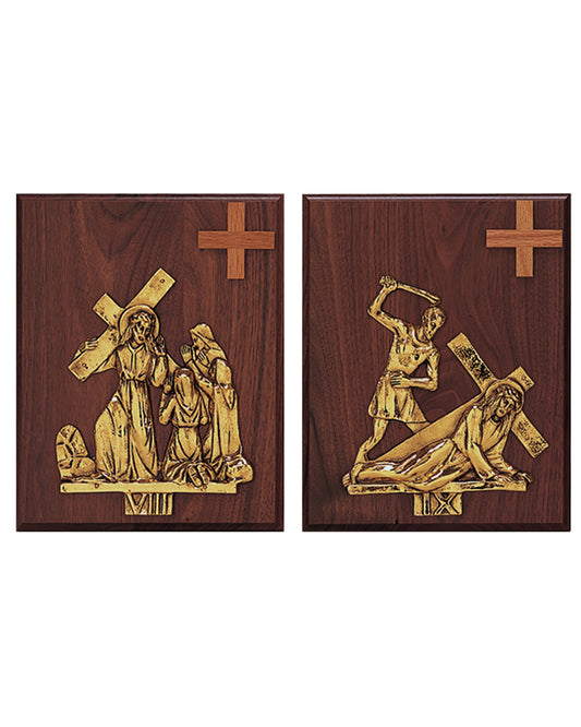 Two wooden plaques with gold religious figures and crosses on a white background