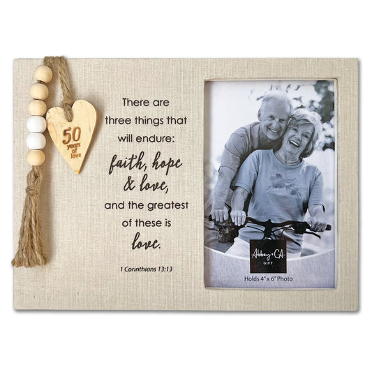Decorative photo frame with a heart-shaped ornament and a quote, featuring an elderly couple on a bike.