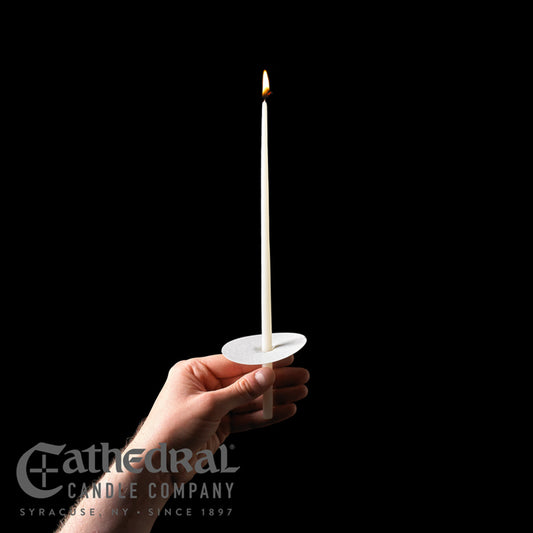 Hand holding a lit candle against a black background with 'Cathedral Candle Company' branding.