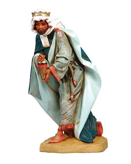 Figure of a wise man from the nativity scene on a white background