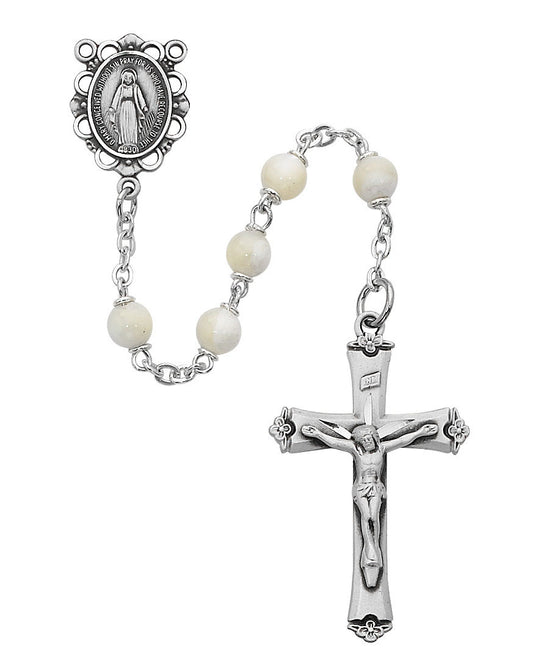 Silver rosary with white beads and crucifix on a white background