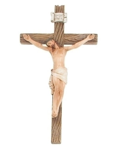 Wooden crucifix with Jesus figure on a white background