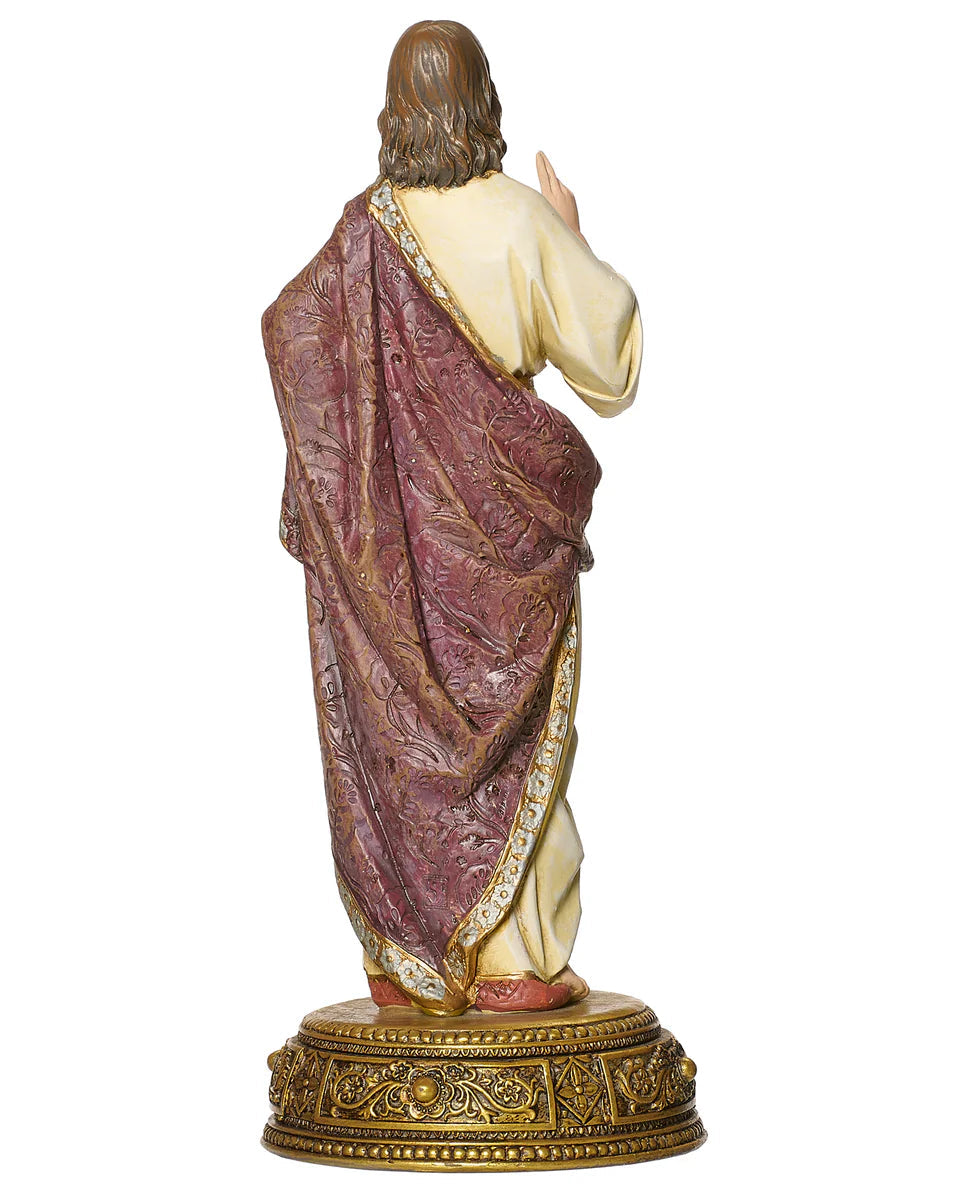 Statue of a religious figure with a purple robe and gold base on a white background