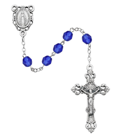 Silver rosary with blue beads on a white background