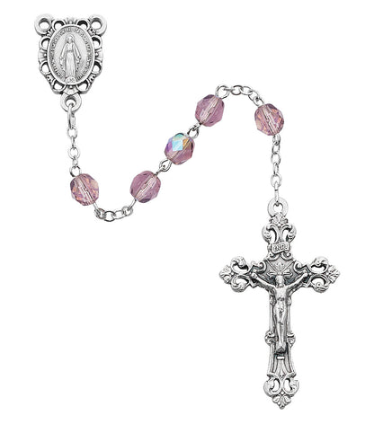 Silver rosary with pink beads on a white background