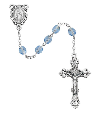 Silver rosary with blue beads on a white background