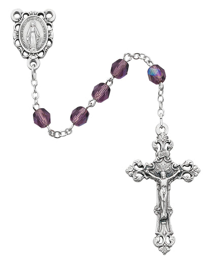 Silver rosary with purple beads on a white background
