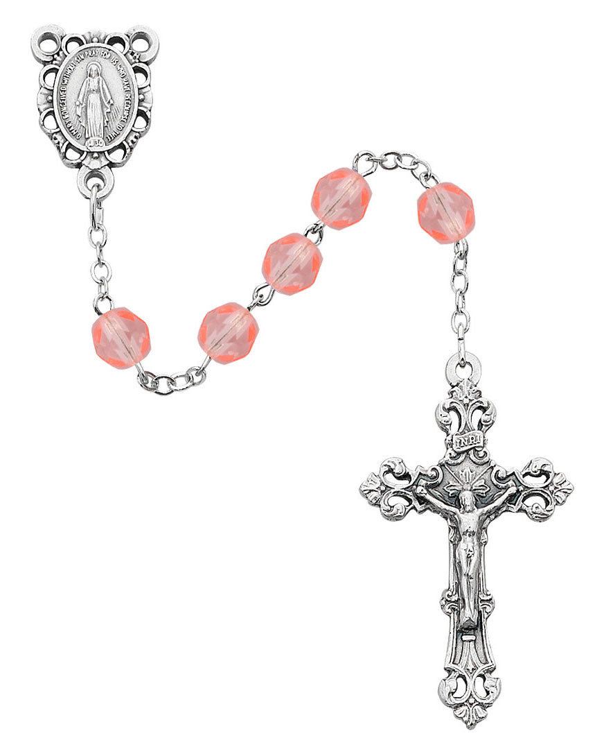 Silver rosary with pink beads on a white background