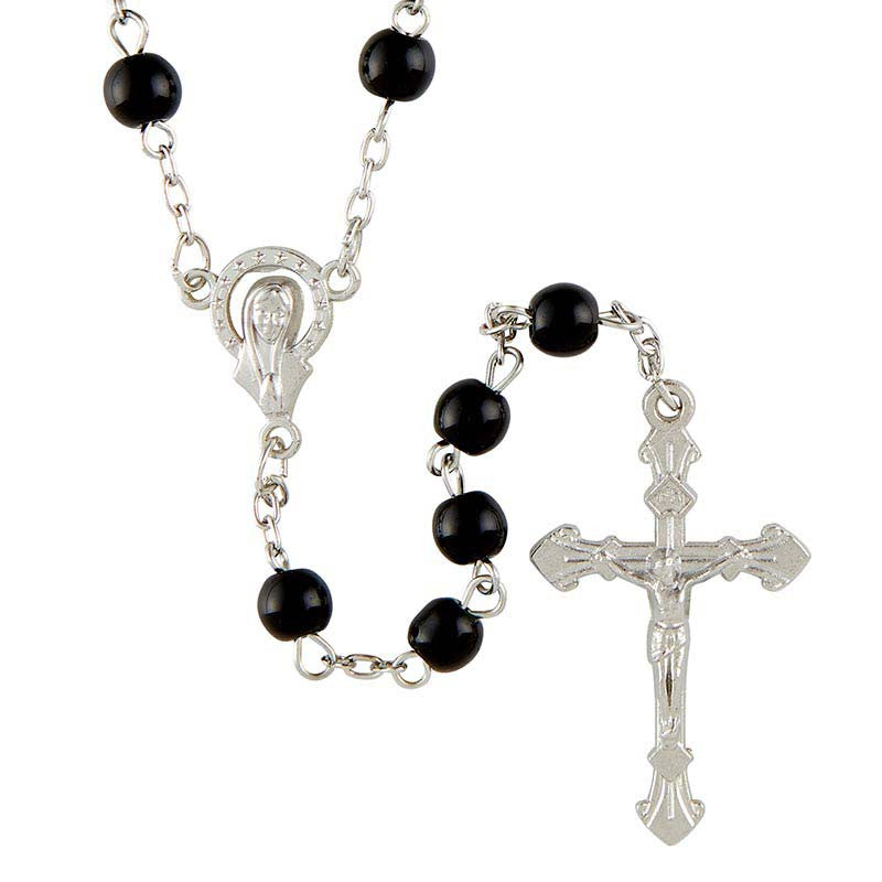 Black rosary beads with silver metal elements on a white background