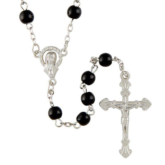 Black rosary beads with silver metal elements on a white background