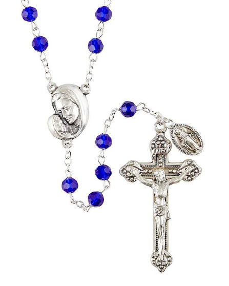 A blue and silver rosary with a centerpiece depicting a mother and child, and a boxed package.