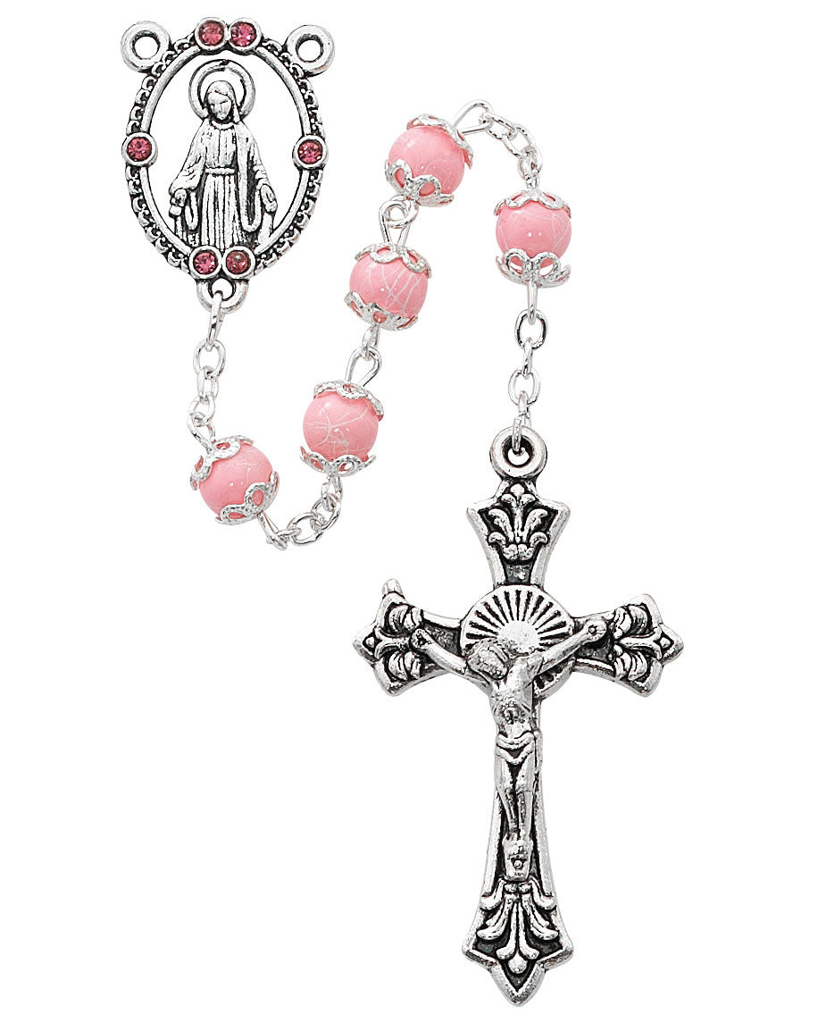 Pink rosary with silver cross and medal on a white background