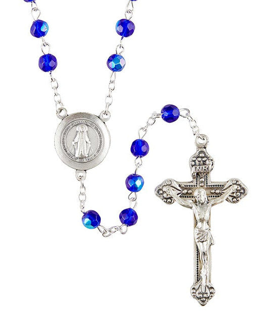 A blue and silver rosary with 6mm beads, featuring a silver oxidized crucifix and centerpiece, along with a Miraculous Medal.