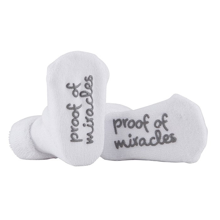 White socks with 'proof of miracles' text on a white background