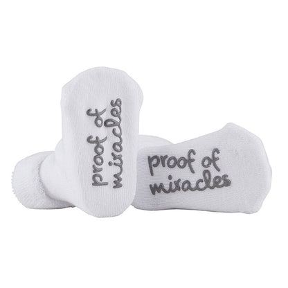 White socks with 'proof of miracles' text on a white background