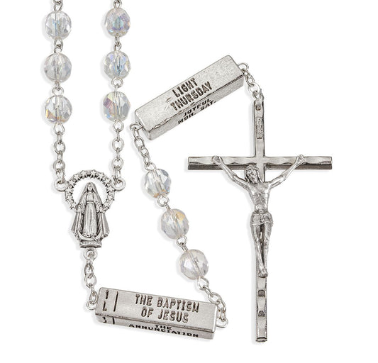 Silver rosary with beads and crucifix on a white background