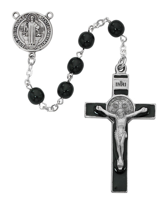 Rosary with black beads and silver crucifix on a white background
