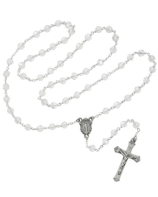 Rosary with white beads and silver cross on a white background