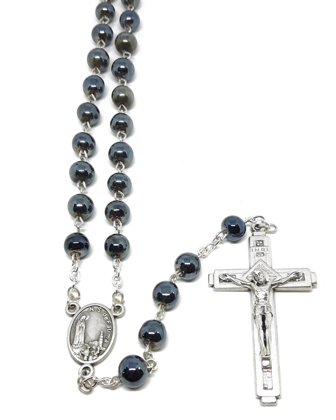 Black rosary with silver crucifix and medal on a white background