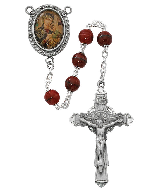 Rosary with red beads and silver crucifix on a white background