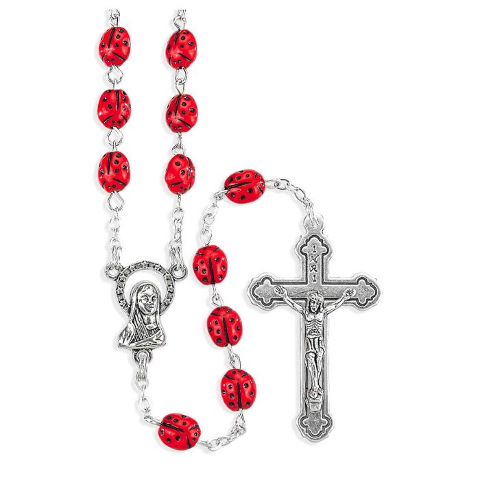 Red rosary with silver crucifix and saint figure on a white background
