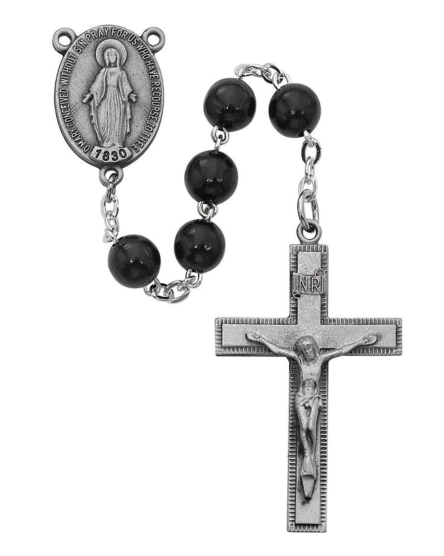 Black rosary with silver crucifix and medal on a white background
