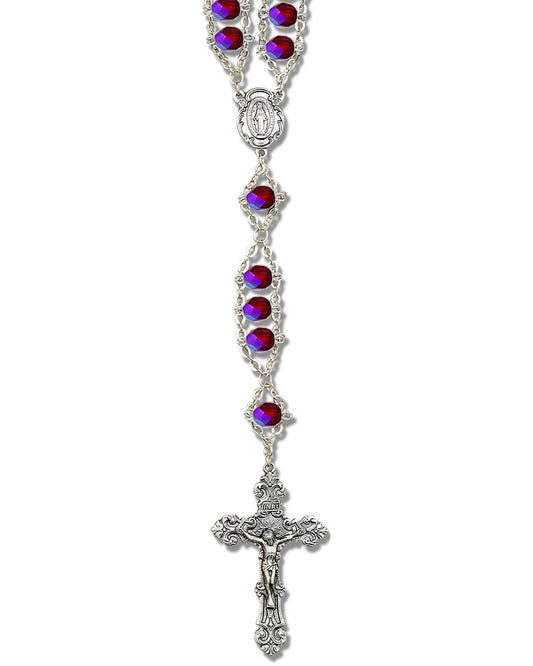 Silver rosary with red and purple gemstones on a white background