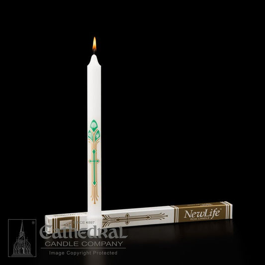 White candle with decorative cross design on a black background, featuring 'NewLife' packaging.