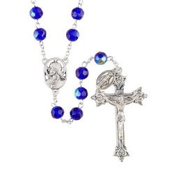 A silver-colored metal rosary with blue glass beads and a silver oxidized crucifix.