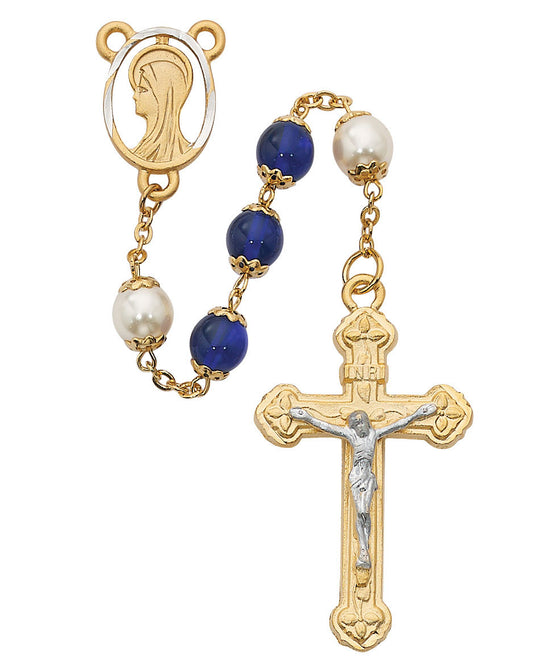 Rosary with blue beads, gold accents, and a crucifix on a white background
