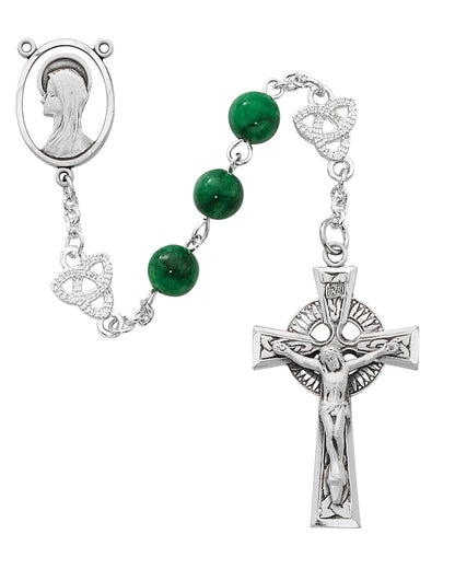 Silver rosary with green beads and a crucifix on a white background