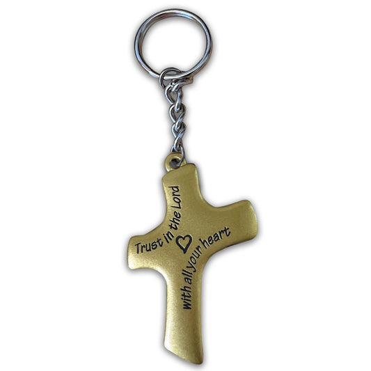 Bronze cross-shaped keychain with engraved text on a white background
