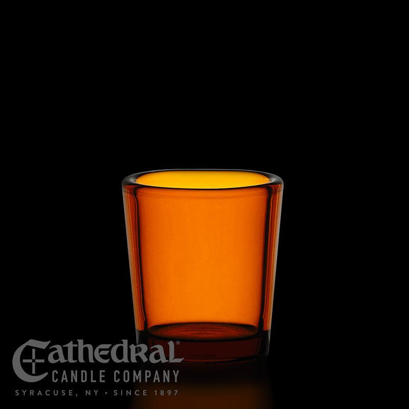 Amber glass candle holder with Cathedral Candle Company logo on a black background