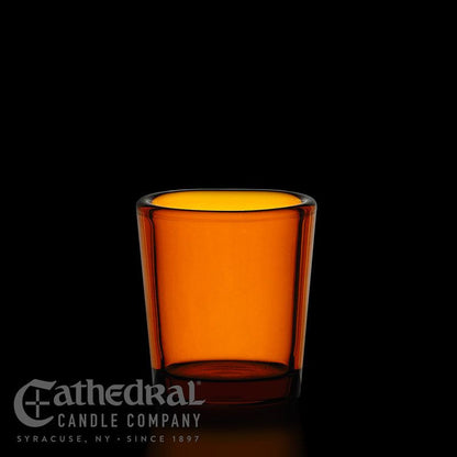 Amber glass candle holder with Cathedral Candle Company logo on a black background