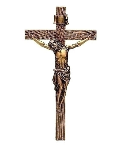 Bronze statue of a crucified figure on a white background