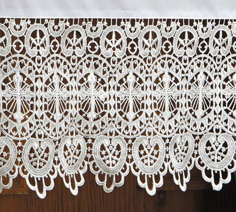 Close-up of intricate white lace fabric on a wooden surface