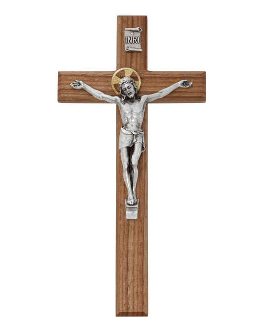 Wooden cross with silver Jesus figure on a white background