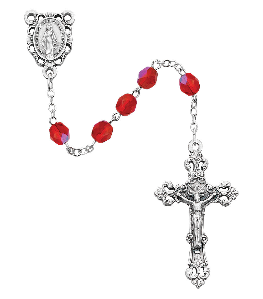 Silver rosary with red beads on a white background