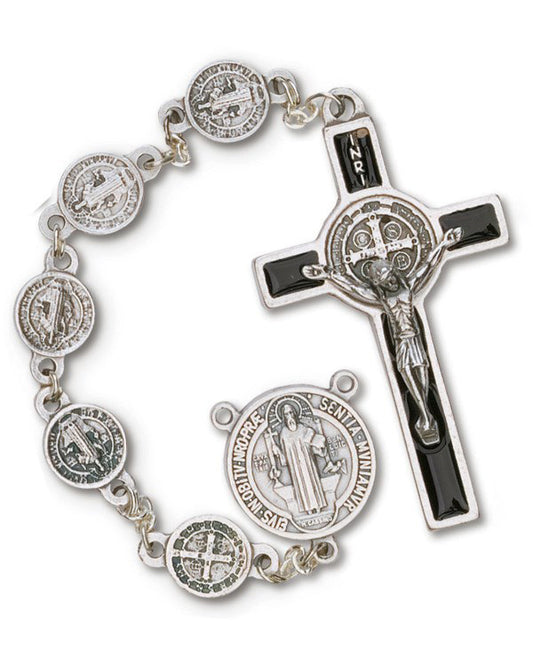 Silver rosary with Saint Benedict medals and a crucifix on a white background