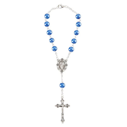 Rosary with blue beads and a silver cross on a white background