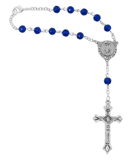 Silver rosary with blue beads on a white background