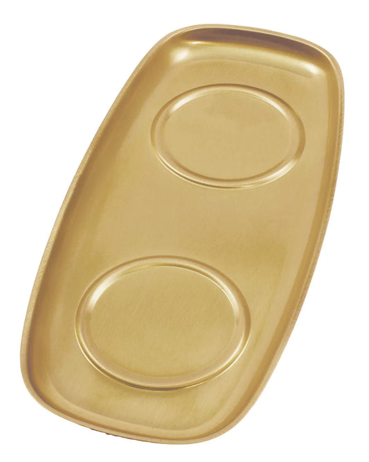 Gold tray with two circular depressions on a white background