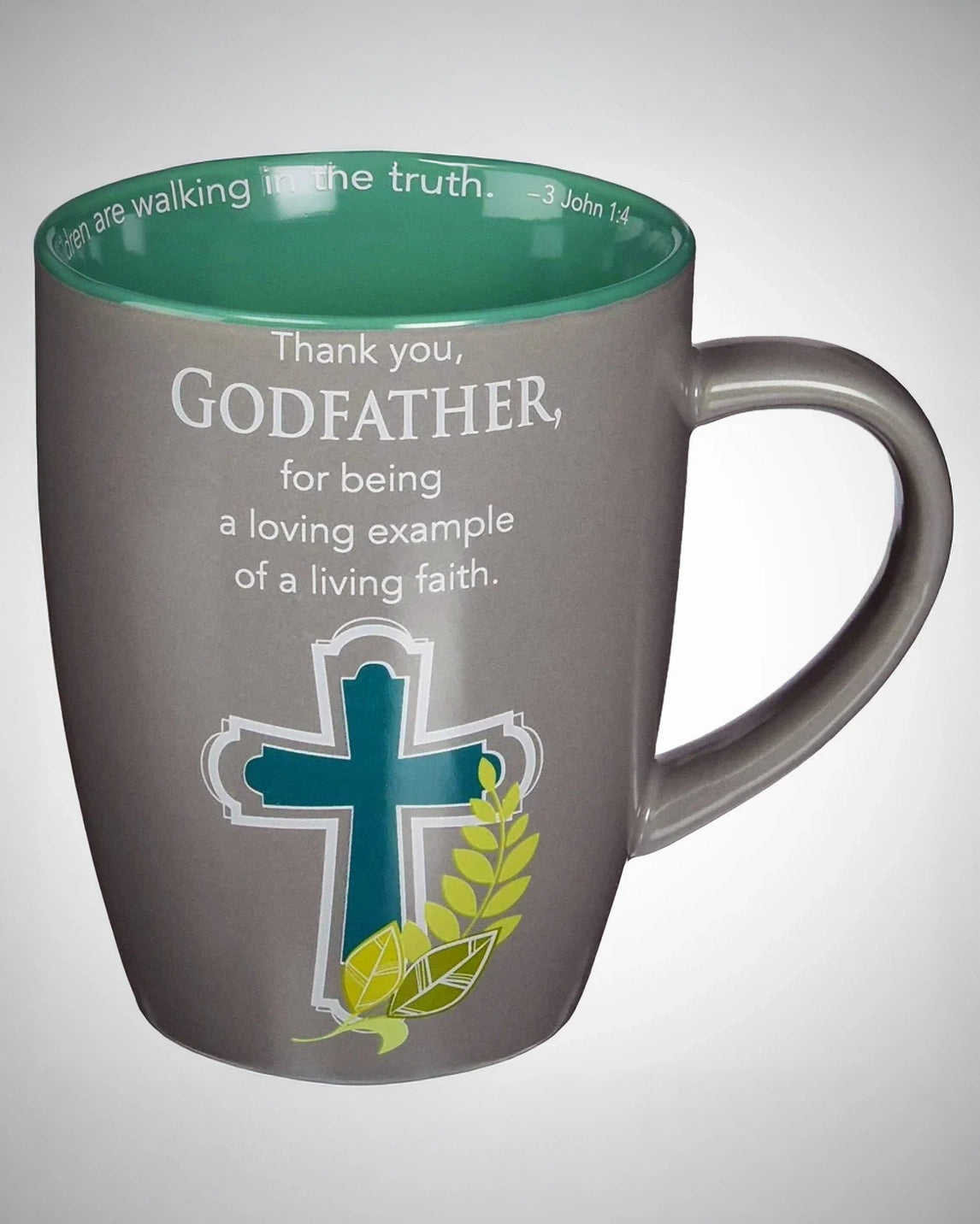 Gray mug with green interior, cross design, and text message on a white background