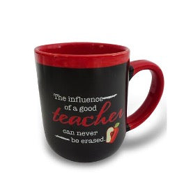 A black ceramic mug with red handle and interior, featuring white text that reads 'The influence of a good teacher can never be erased' along with an image of an apple.