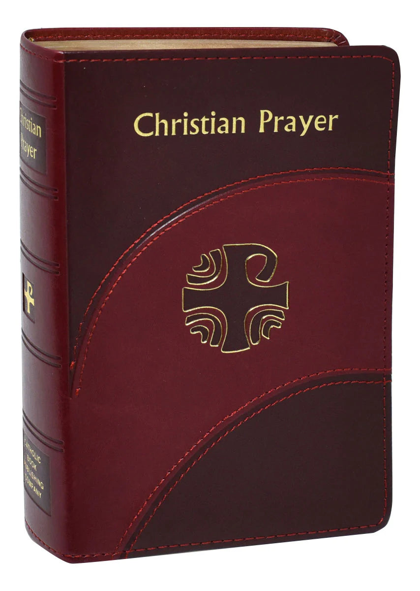 Maroon prayer book with gold text and cross emblem on a white background