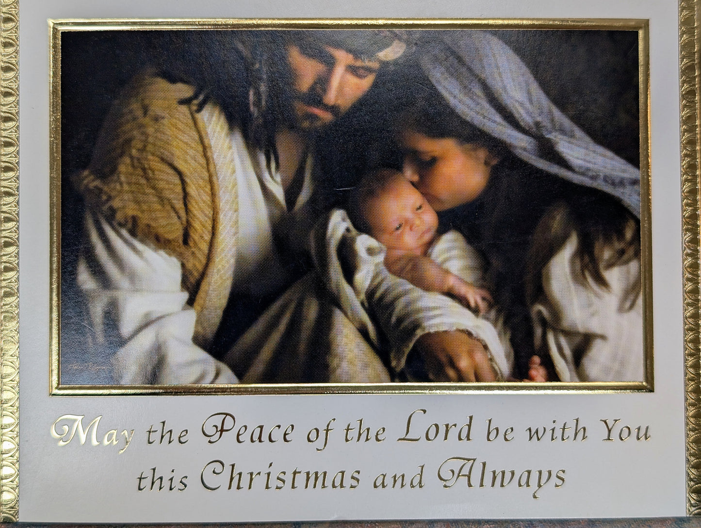 Framed artwork of a nativity scene with text 'May the Peace of the Lord be with You this Christmas and Always'.