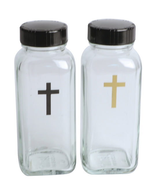 Two glass jars with black lids and crosses on a white background