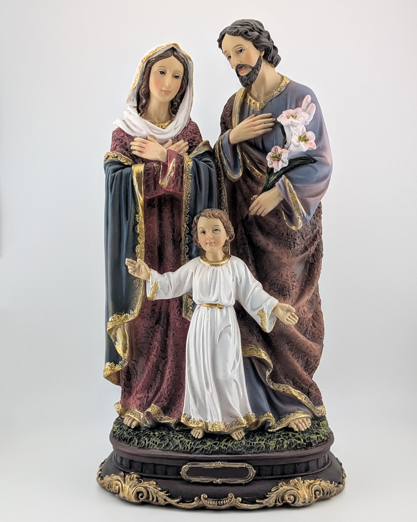 Statue of the Holy Family with Mary, Joseph, and Jesus on a white background
