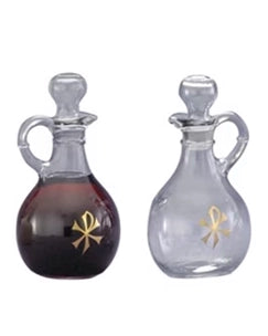 Two glass bottles with gold bows on a white background
